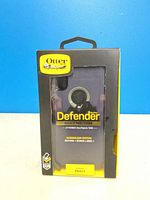 Front view of sealed OtterBox Defender Series iPhone X case packaging