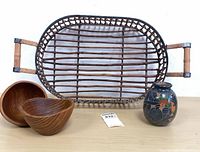 Group shot of reed tray, two wooden bowls, ceramic vase