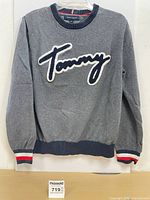 Front view of sweater showing chenille logo and overall condition