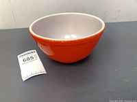 Top angled view of red Pyrex bowl showing exterior color and white interior