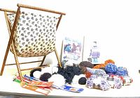 Overall lot showing basket, yarn, pattern book and needles