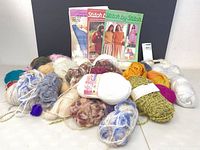 Group shot of assorted yarn balls and three pattern books