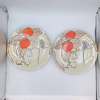Two matching bird motif plates front view