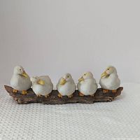 full view of ceramic ducks on log figurine