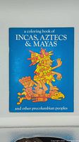 Front cover showing title and coloured pre-Columbian figure