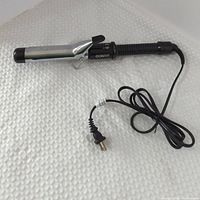 Full view of curling iron showing barrel, handle, and cord