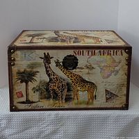 Front view showing giraffe graphics, clasp, brass corners