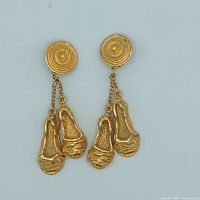 Front view of gold-tone DKNY clip-on earrings with dangling ballet slipper charms