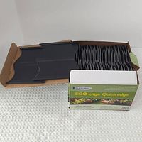 Full view of open box showing stacked edging pieces and product label