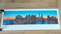 Full view of rolled-out panoramic poster showing entire New York skyline