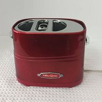 Front view of red Nostalgia Retro Series hot dog toaster