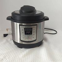 Front view of Instant Pot Lux Mini showing control panel and stainless body