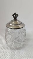 Full view of candy jar showing cut glass body and silver-plated lid with finial