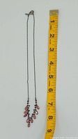 Full view of necklace beside measuring tape showing length