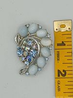 Front view showing cabochons and rhinestone cluster with ruler for scale