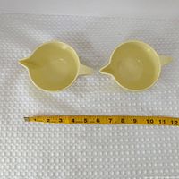 Top view of both creamers with tape measure for scale