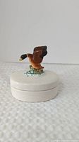 Closed trinket box showing duck figurine on lid