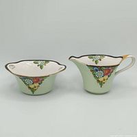 Front view of both Noritake pieces showing shape, colour and motif