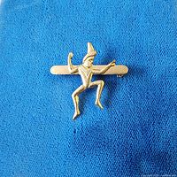 front view of brooch on blue fabric