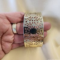 Front view wide gold-tone cuff with floral cut-outs
