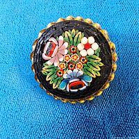 Front view showing micro mosaic floral design and rope border