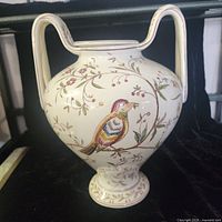 Front view of porcelain vase showing bird motif and handles