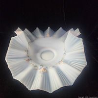 Top view of pale blue satin glass bowl showing ruffled rim and floral garland decoration
