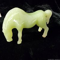 Left side view of pale green horse figurine