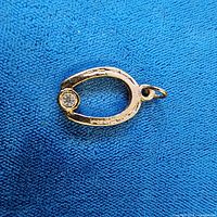 Front view of horseshoe pendant showing stone and bail