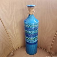 Front view of tall blue glazed ceramic vase
