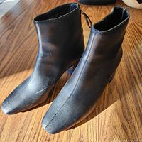 Side view of both boots showing upper material and toe shape