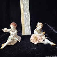 Front view of both figurines with ruler for scale