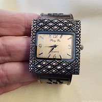 Front view showing dial, crystal-accent bezel, brand name