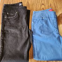 Black and blue pull-on jeans folded side by side