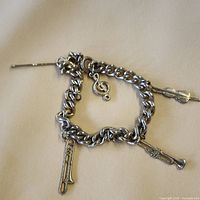 Full bracelet with toggle clasp and three music charms