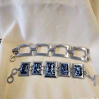 Both bracelets laid flat on fabric showing overall designs