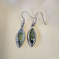 Front view showing green stone inlay and swirl design