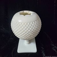 Front view of white milk glass hobnail pedestal vase