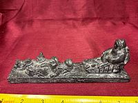 Side view of entire soapstone dog sled sculpture