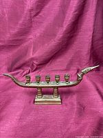 Full view of brass boat candle holder showing five cups and base