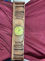 Full view of long rectangular wooden mantel clock