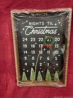 Front view of wood framed countdown sign, shrink-wrapped