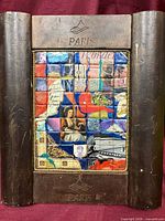 Front view of framed mixed-media collage artwork in carved Paris wood frame
