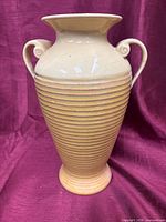 Full view of vase front showing ribbed body and scroll handles