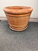 Side view of terracotta planter with saucer