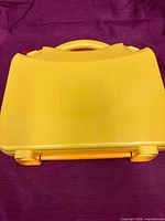 Yellow LEGO carrying case closed, front view