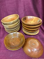 Two stacks of wooden bowls plus two single bowls showing interiors and exteriors