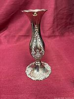 Full front view of silver-plated vase showing relief design and shape