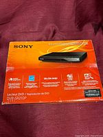 Front of sealed Sony DVP-SR210P retail box