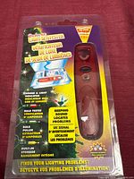 Front of sealed blister pack showing red tester and feature list